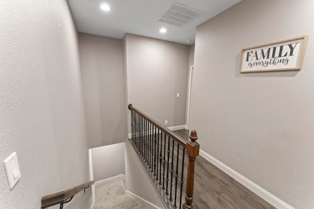 staircase with hardwood / wood-style flooring