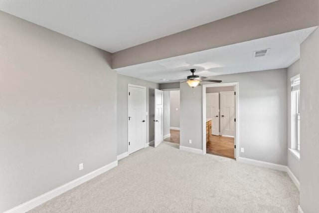 carpeted spare room with ceiling fan