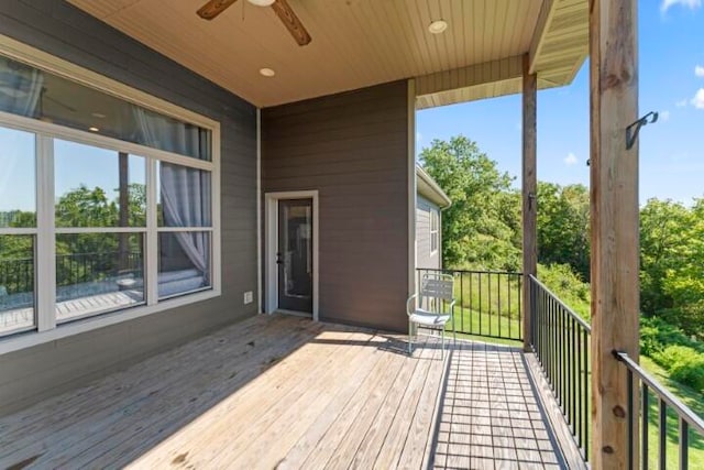 wooden deck featuring ceiling fan