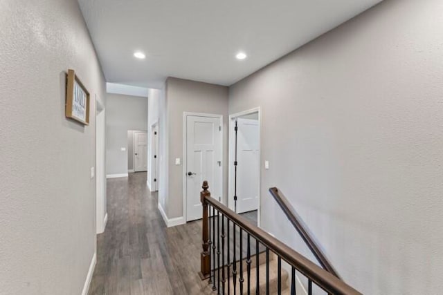 corridor with dark hardwood / wood-style flooring