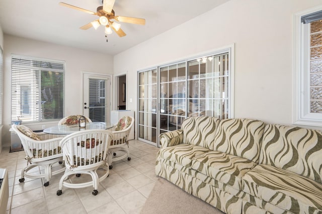 interior space featuring light tile patterned floors and ceiling fan