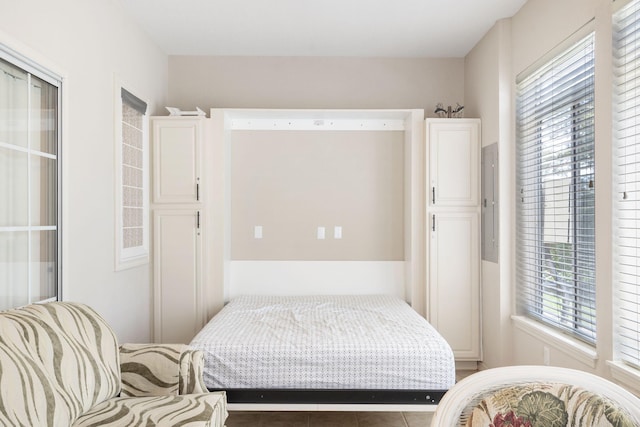 tiled bedroom featuring multiple windows