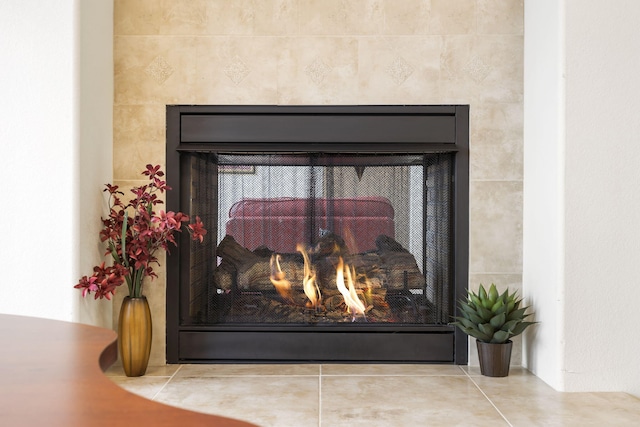 interior details featuring a tiled fireplace