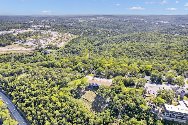 birds eye view of property featuring a wooded view