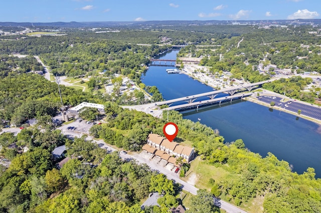 birds eye view of property featuring a wooded view and a water view