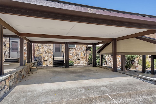 exterior space featuring stone siding and a carport