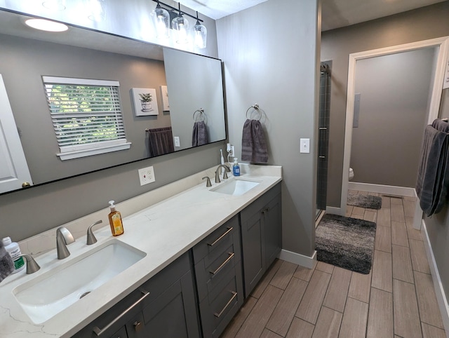 bathroom featuring vanity and a shower with shower door