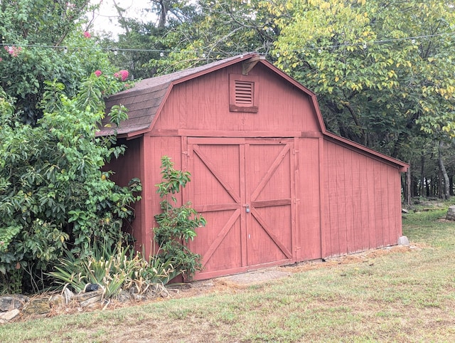 view of outbuilding with a yard