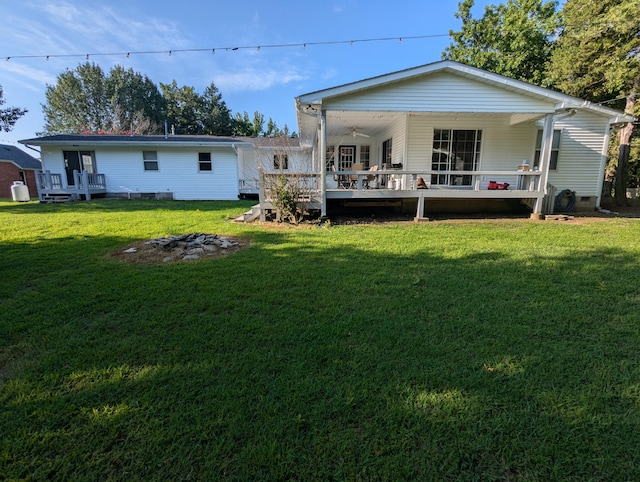 rear view of house with a yard