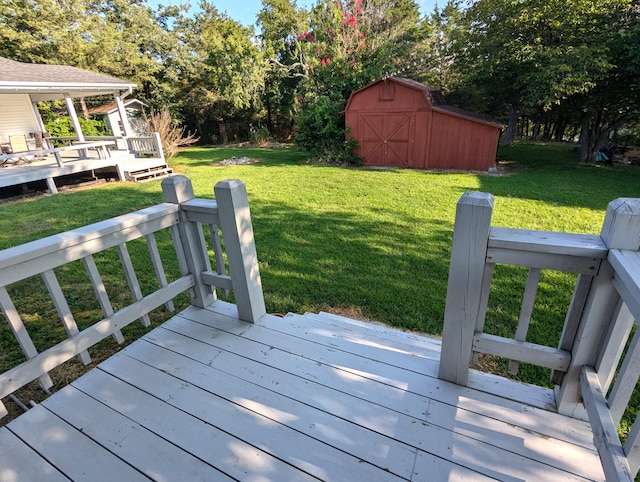 wooden terrace with a yard and a shed