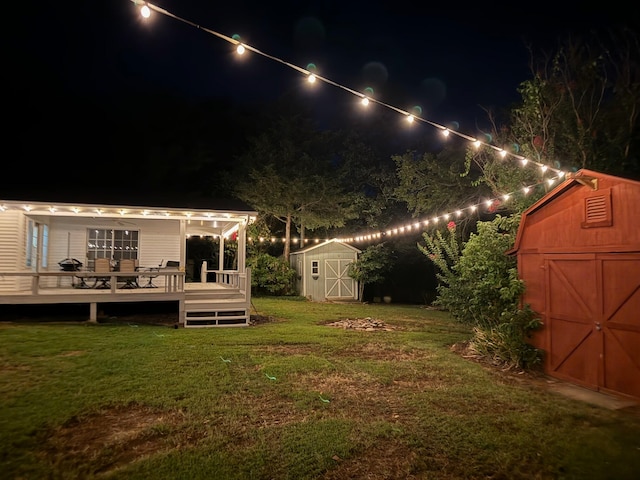 yard at twilight featuring a shed and a deck