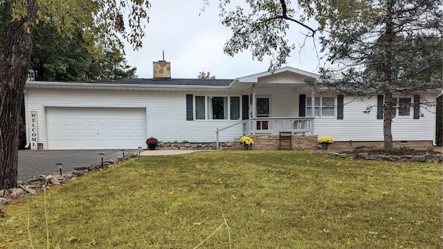 single story home with covered porch, a garage, and a front yard