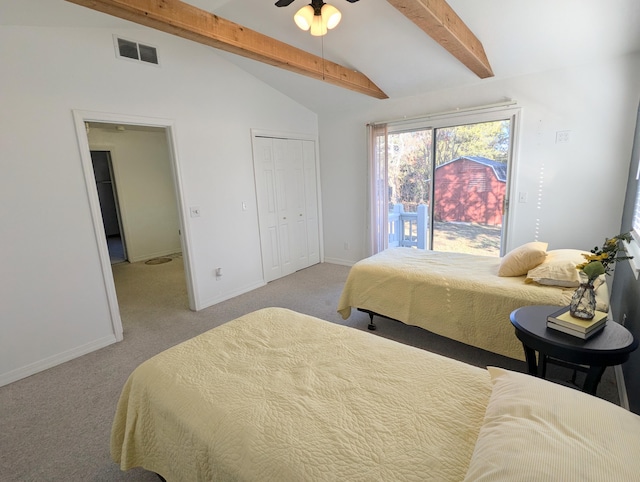 carpeted bedroom with lofted ceiling with beams, a closet, and ceiling fan