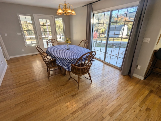 dining room featuring a chandelier and light hardwood / wood-style flooring