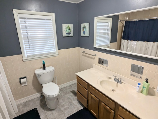 bathroom featuring vanity, tile patterned floors, a shower with shower curtain, toilet, and tile walls