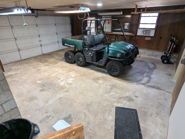 garage featuring wood walls