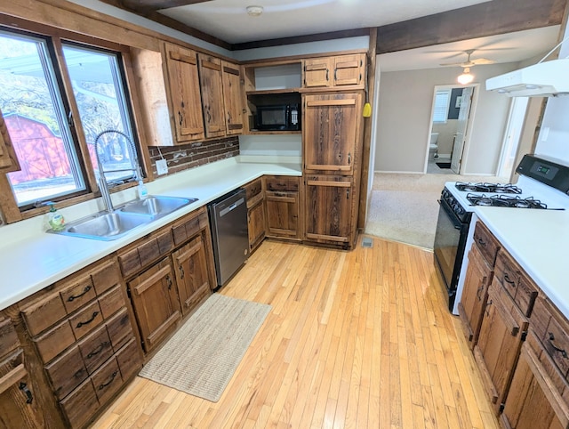 kitchen featuring white gas range, stainless steel dishwasher, range hood, and light hardwood / wood-style floors