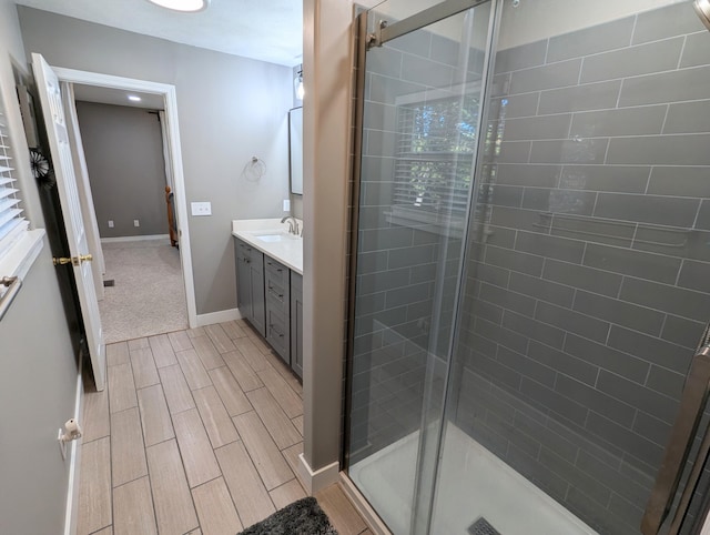 bathroom featuring vanity and a shower with door