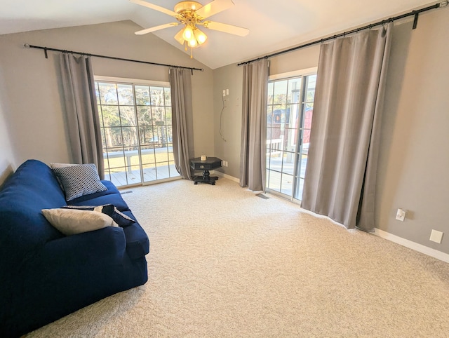 living area with carpet, ceiling fan, lofted ceiling, and a wealth of natural light