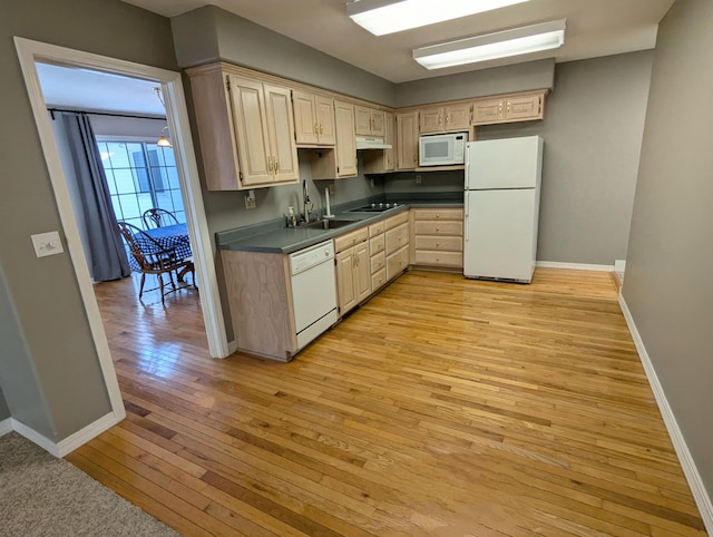 kitchen featuring white appliances, sink, light brown cabinetry, and light hardwood / wood-style flooring