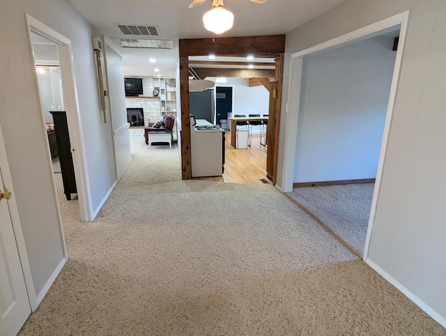 hall featuring light colored carpet