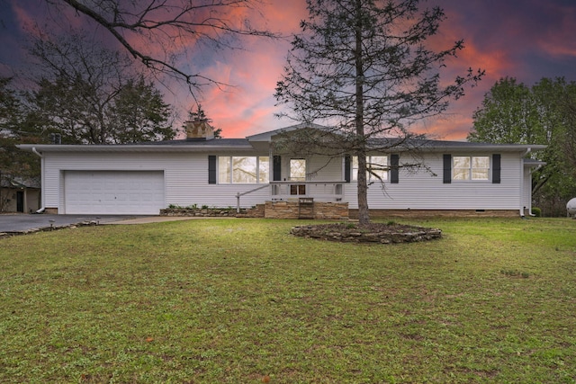 single story home featuring driveway, an attached garage, and a front lawn