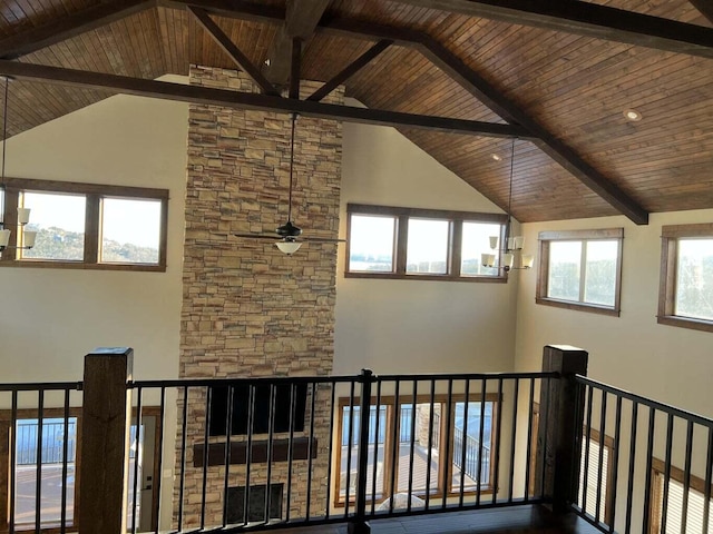 hallway featuring high vaulted ceiling, a healthy amount of sunlight, and wood ceiling