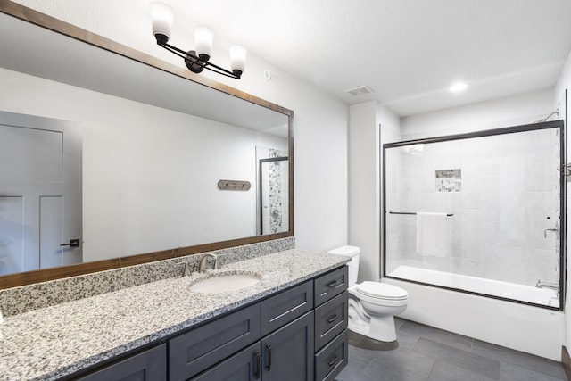 full bathroom featuring vanity, enclosed tub / shower combo, and toilet