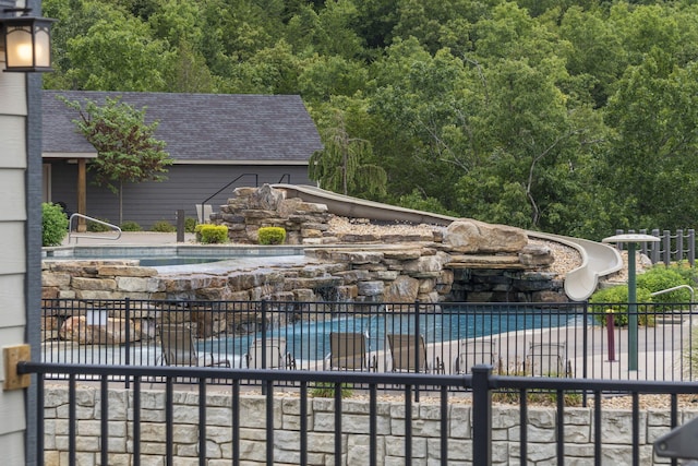 view of swimming pool with a water slide