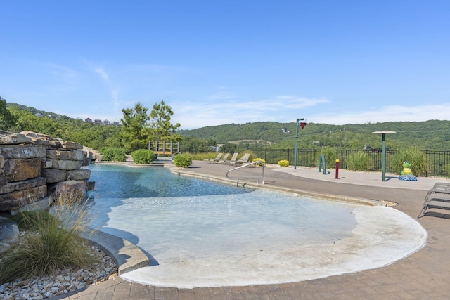 view of swimming pool featuring a mountain view