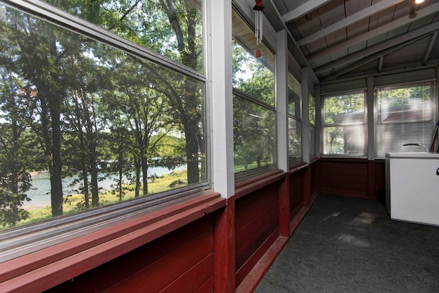 unfurnished sunroom with a water view, a wealth of natural light, and lofted ceiling