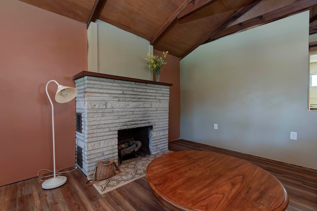 living room with wood-type flooring, vaulted ceiling with beams, a brick fireplace, and wood ceiling