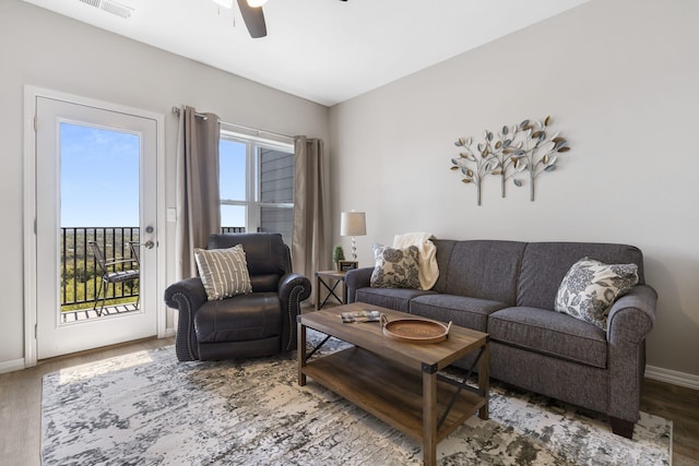 living room featuring ceiling fan and hardwood / wood-style flooring