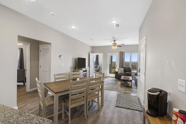 dining area featuring ceiling fan and dark wood-type flooring