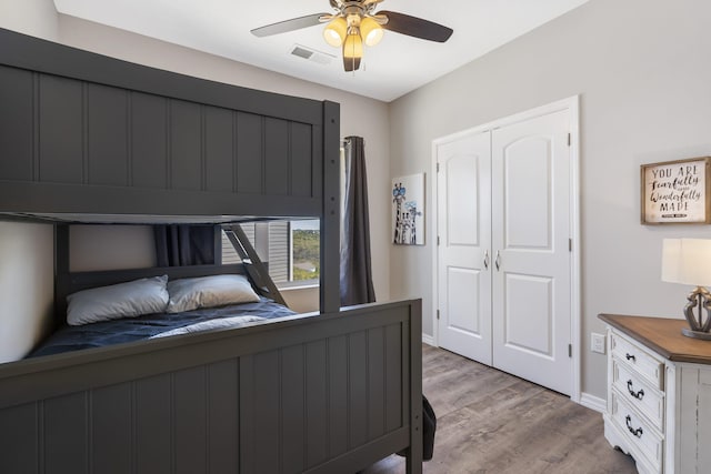 bedroom featuring ceiling fan, a closet, and light hardwood / wood-style flooring