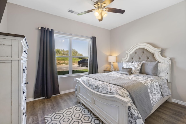 bedroom with ceiling fan and dark wood-type flooring