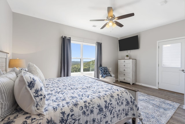 bedroom with ceiling fan and hardwood / wood-style floors