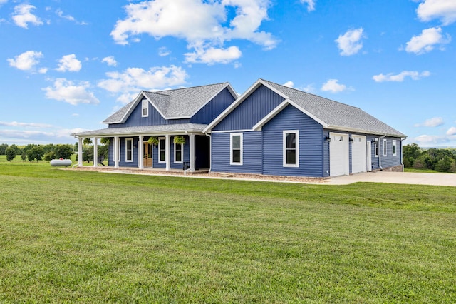 view of front facade with a front lawn, covered porch, and a garage