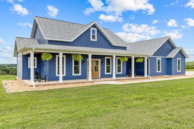 view of front of house featuring a porch, roof with shingles, board and batten siding, and a front yard