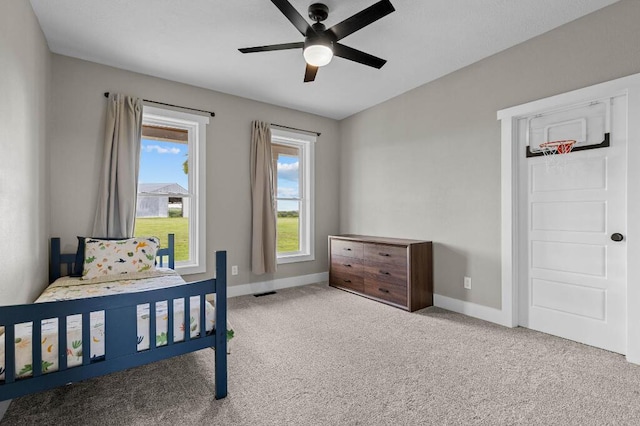 bedroom with visible vents, a ceiling fan, baseboards, and carpet floors