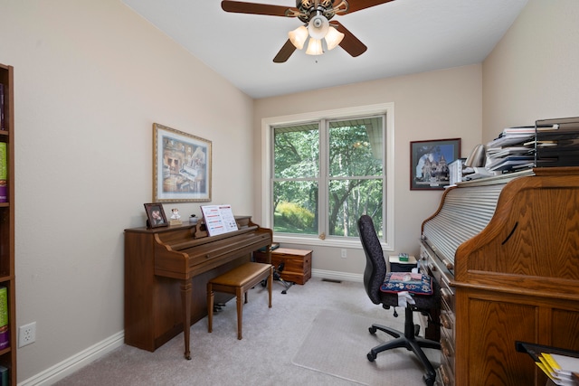 carpeted office space featuring ceiling fan