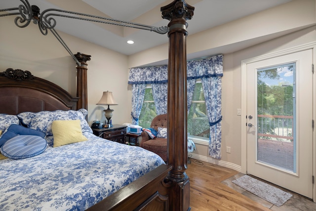 bedroom with access to outside and light hardwood / wood-style floors