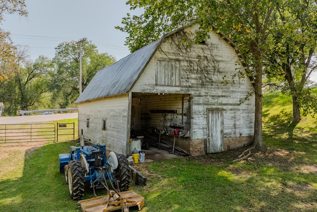 view of outbuilding featuring a yard