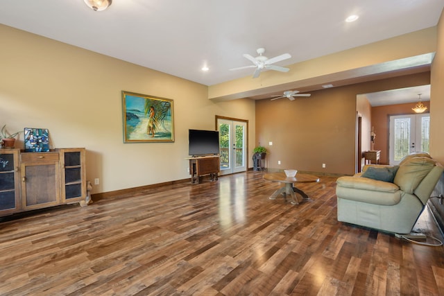 living room featuring wood-type flooring and ceiling fan