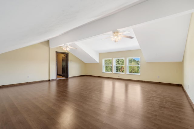 additional living space featuring vaulted ceiling and dark hardwood / wood-style flooring