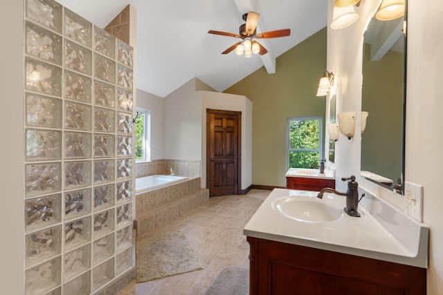 bathroom featuring plenty of natural light, vaulted ceiling, and vanity