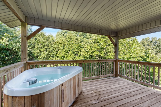 wooden deck with a hot tub