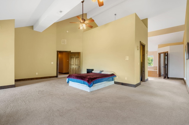 carpeted bedroom featuring ceiling fan, ensuite bathroom, beamed ceiling, and high vaulted ceiling