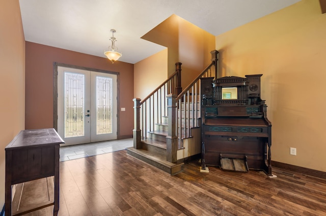 entryway with hardwood / wood-style floors and french doors