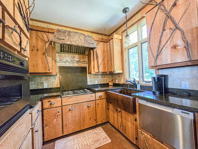 kitchen featuring crown molding, dark stone countertops, sink, backsplash, and appliances with stainless steel finishes